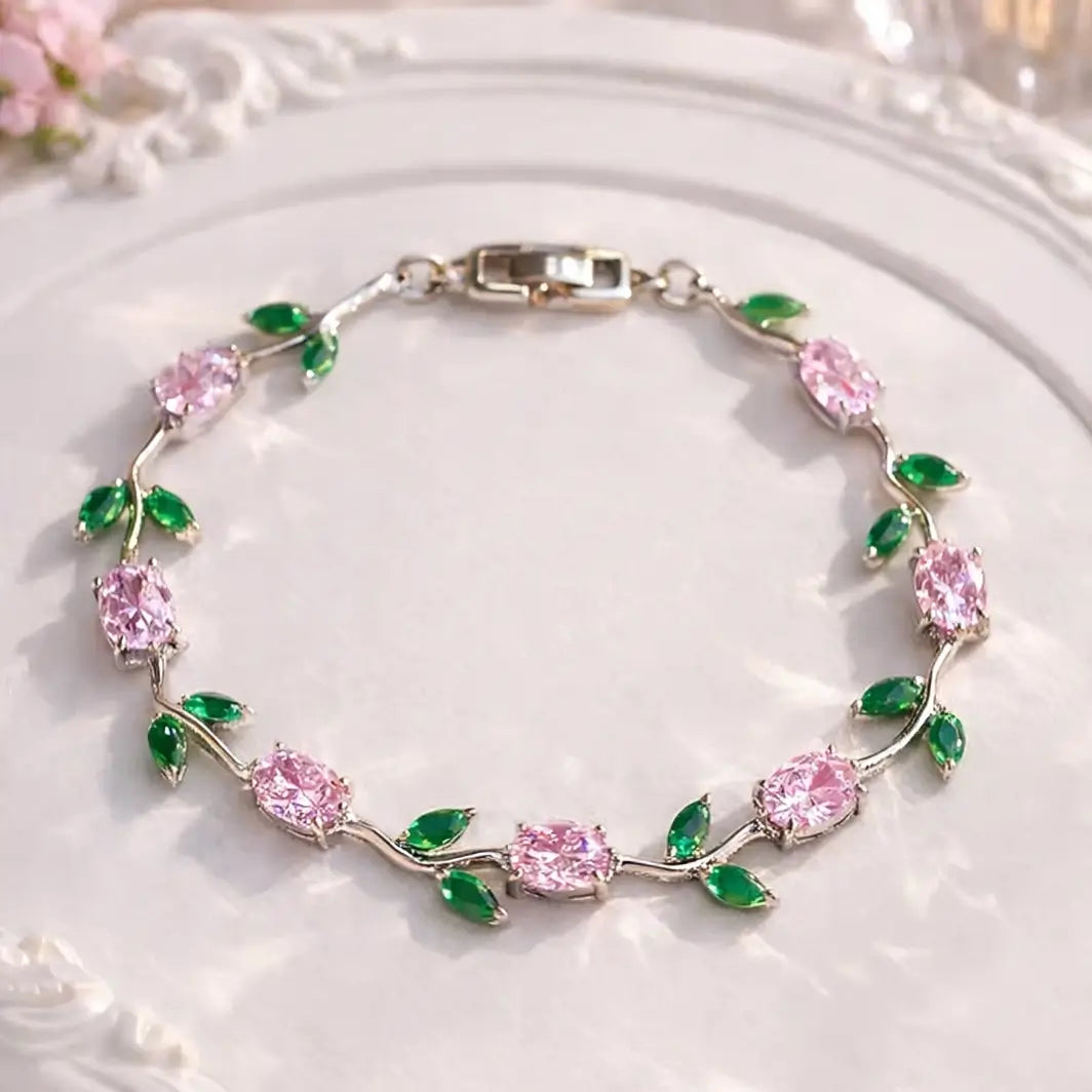 Silver-plated tulip bracelet features pink oval stones and green leaf accents