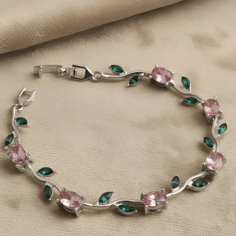 Silver-plated tulip bracelet features pink oval stones and green leaf accents