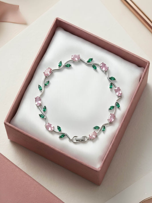 Silver-plated tulip bracelet features pink oval stones and green leaf accents